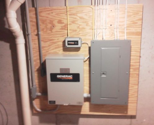 generac system on a wall next to a breaker box