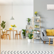 a gray room with yellow accents with a ductless mitsubishi system on the wall