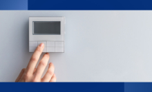 person touching a blank thermostat