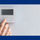 person touching a blank thermostat