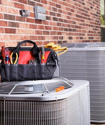 Residential central air conditioning unit being serviced by a professional in Mechanicsburg.